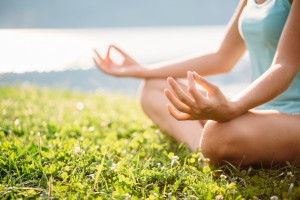 Detail of woman meditating in the nature